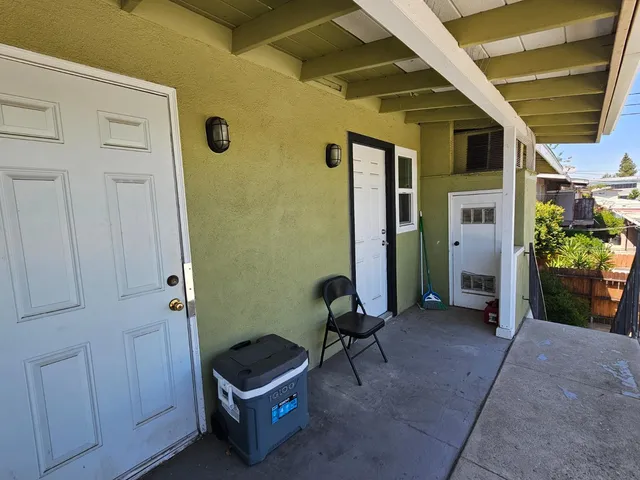 a view of balcony with wooden floor and seating space