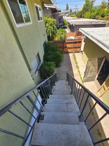 a view of a street with potted plants