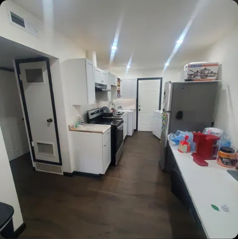 a kitchen with stainless steel appliances a stove top oven a refrigerator a sink and dishwasher