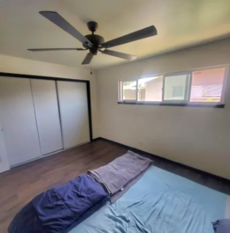a view of a livingroom with a ceiling fan and wooden floor