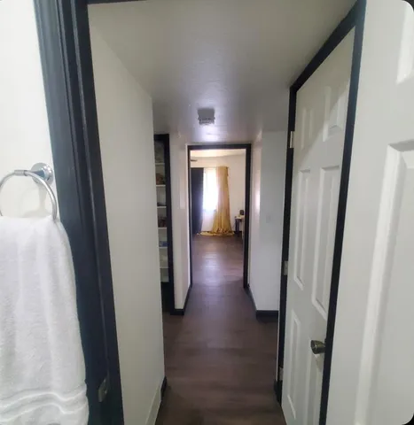 a view of hallway with wooden floor
