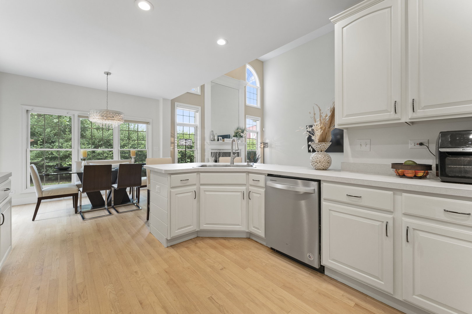 4308 Royal Windyne Court St. Charles, IL 60174 - Photo 11 of 47 a kitchen with white cabinets and wooden floors