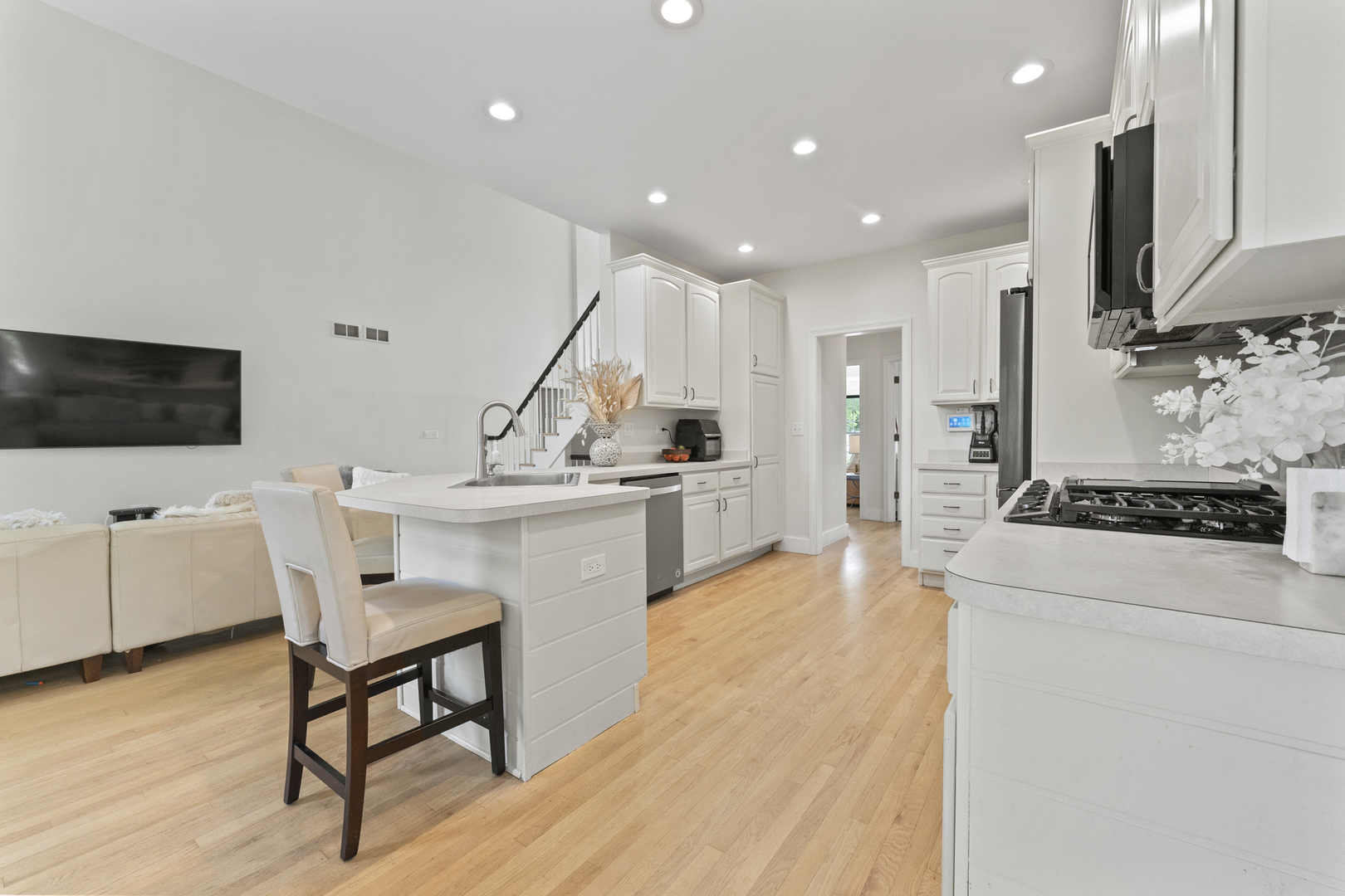 4308 Royal Windyne Court St. Charles, IL 60174 - Photo 12 of 47 a kitchen with stainless steel appliances kitchen island granite countertop a sink a stove a microwave a refrigerator and cabinets