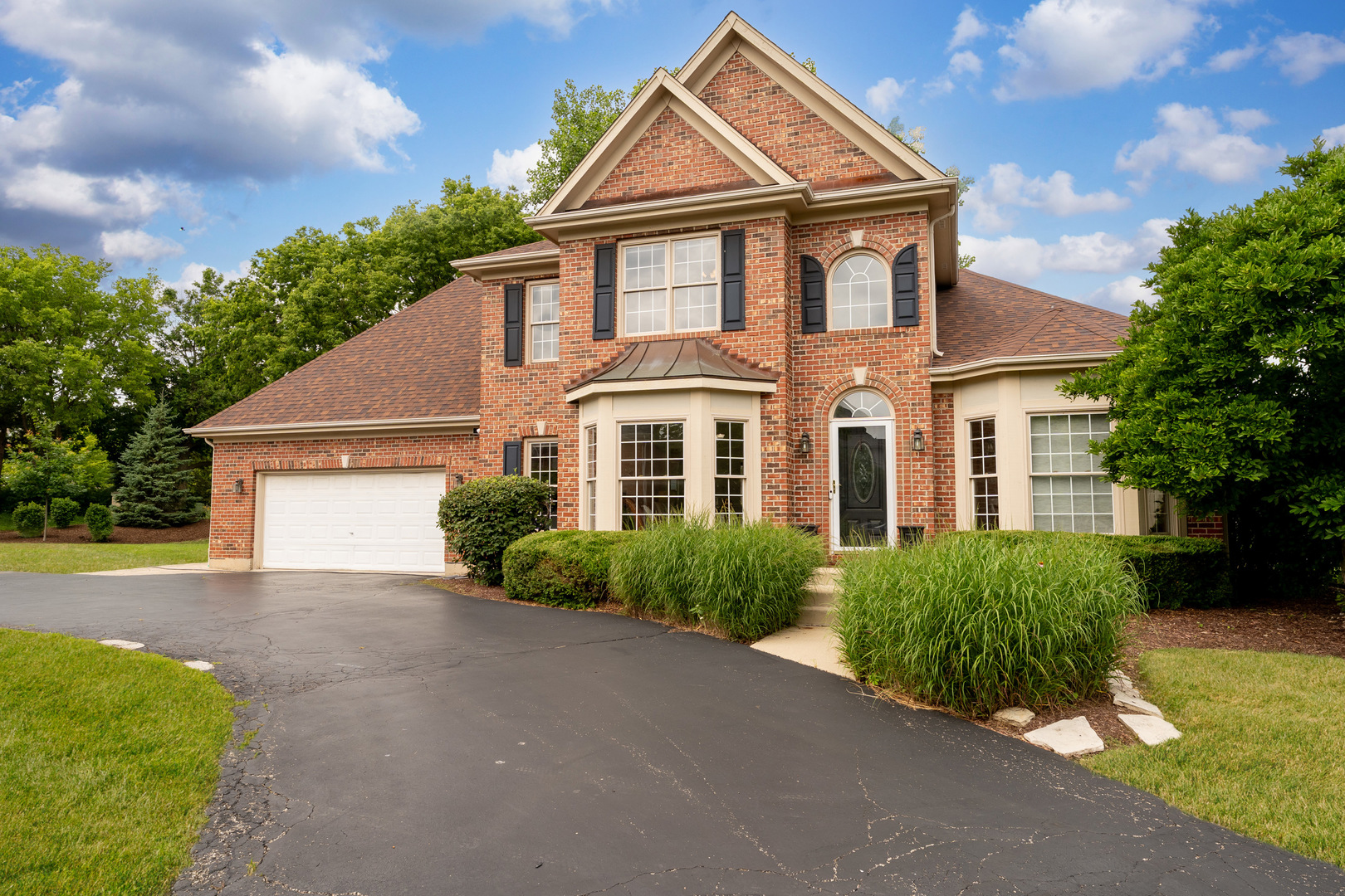 4308 Royal Windyne Court St. Charles, IL 60174 - Photo 2 of 47 a front view of a house with a yard and garage