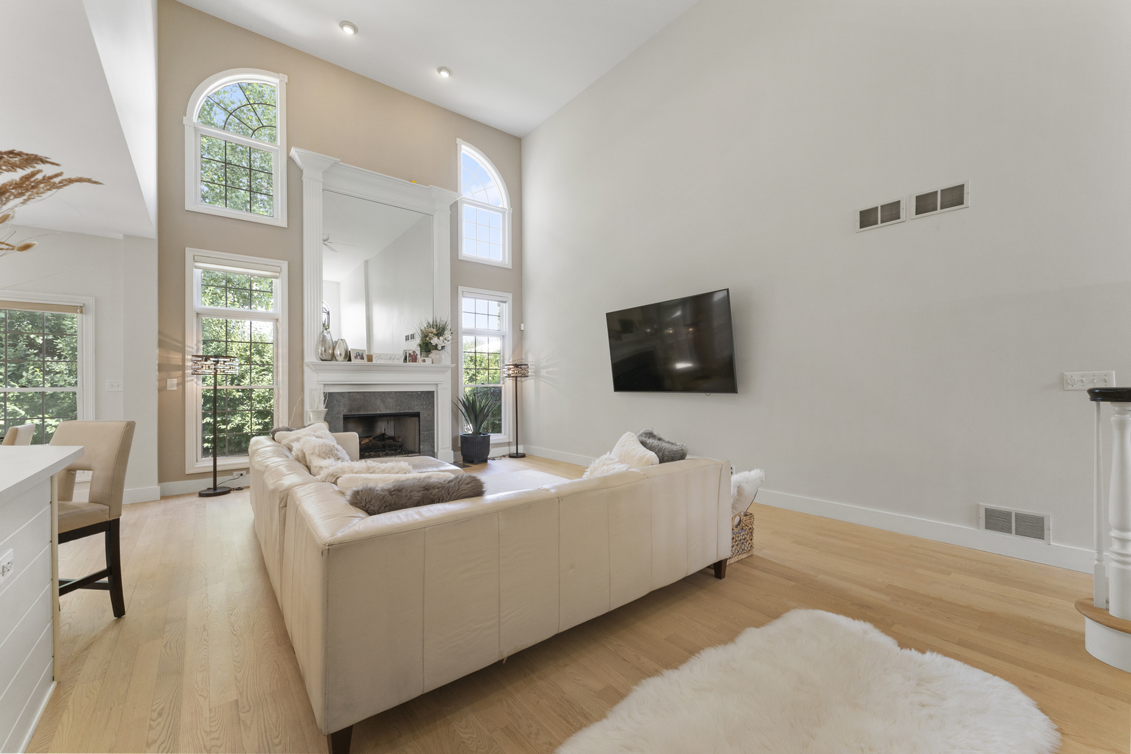 4308 Royal Windyne Court St. Charles, IL 60174 - Photo 7 of 47 a living room with furniture a fireplace and a flat screen tv