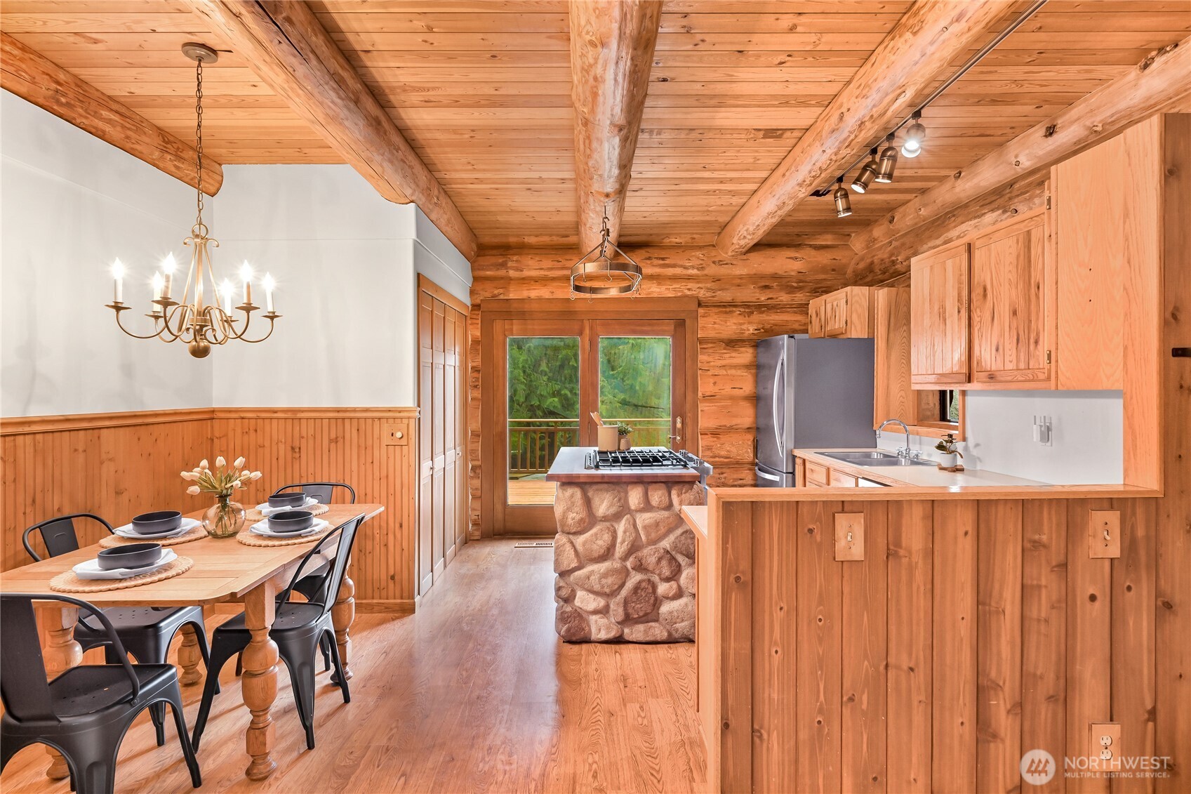 498 Summerland Road Bellingham, WA 98229 - Photo 13 of 40 a dining room with furniture a chandelier and wooden floor