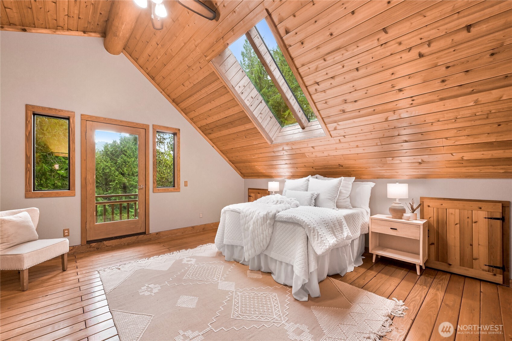 498 Summerland Road Bellingham, WA 98229 - Photo 18 of 40 a spacious bedroom with a bed and wooden floor