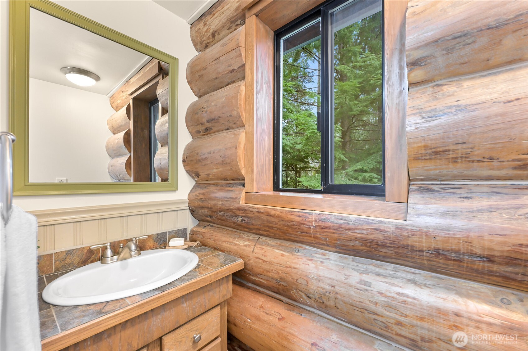 498 Summerland Road Bellingham, WA 98229 - Photo 26 of 40 a bathroom with a sink and a mirror