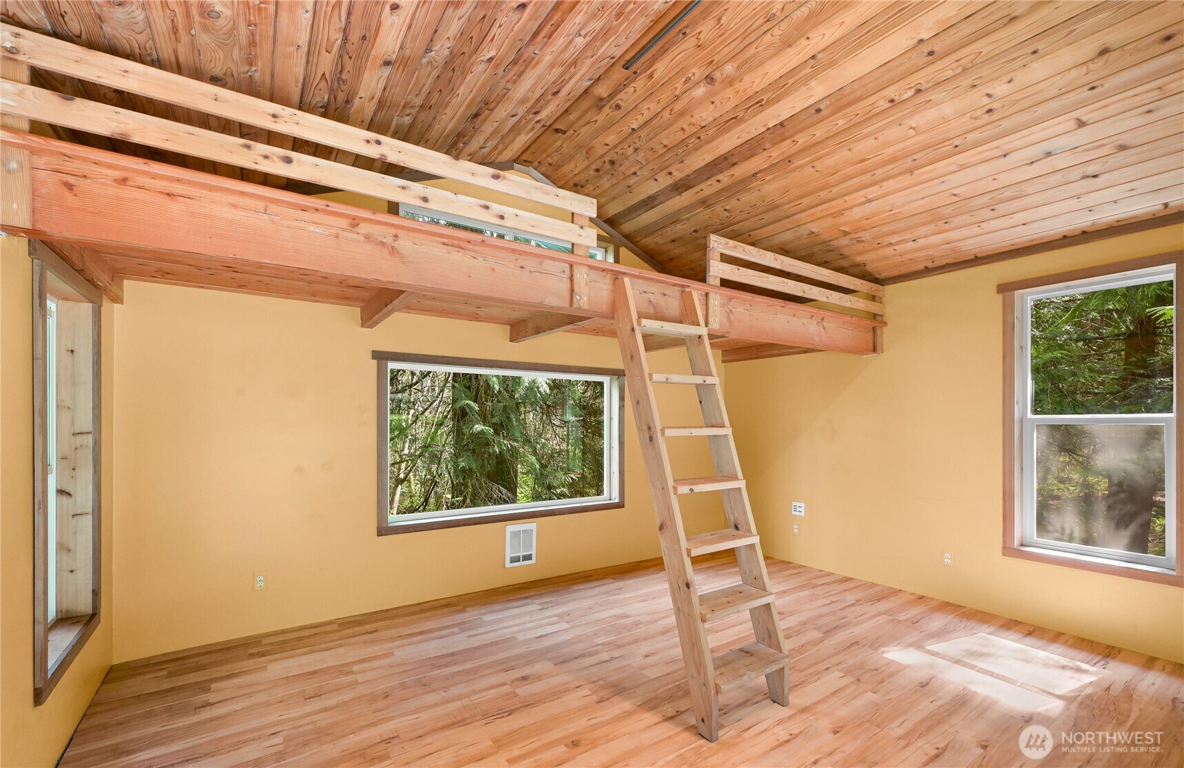 498 Summerland Road Bellingham, WA 98229 - Photo 30 of 40 a view of an empty room with wooden floor and a window