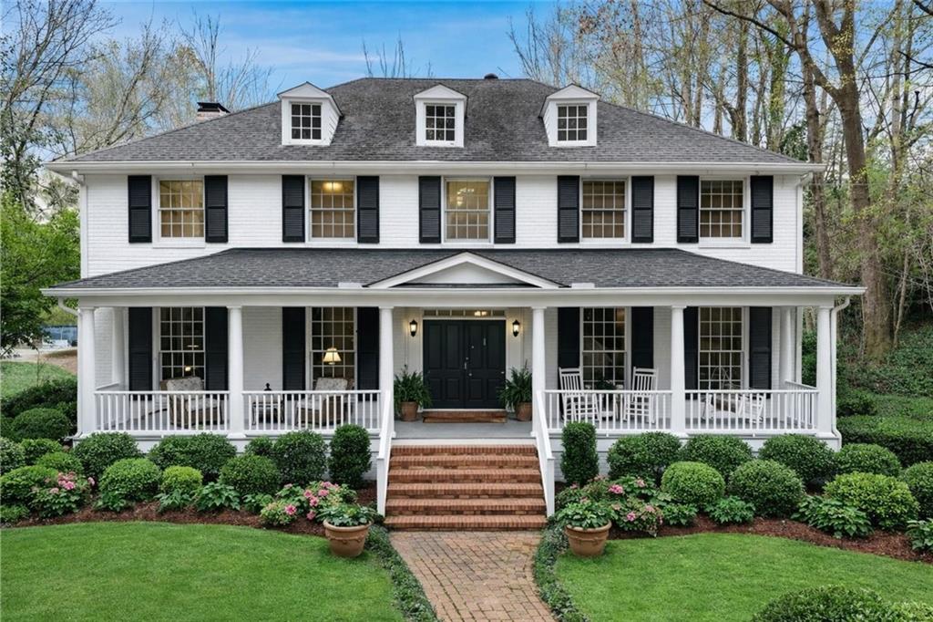 956 West Wesley Road Northwest Atlanta, GA 30327 - Photo 2 of 49 a front view of a house with a garden