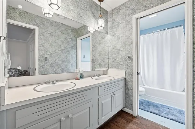 a bathroom with a double vanity sink and a mirror