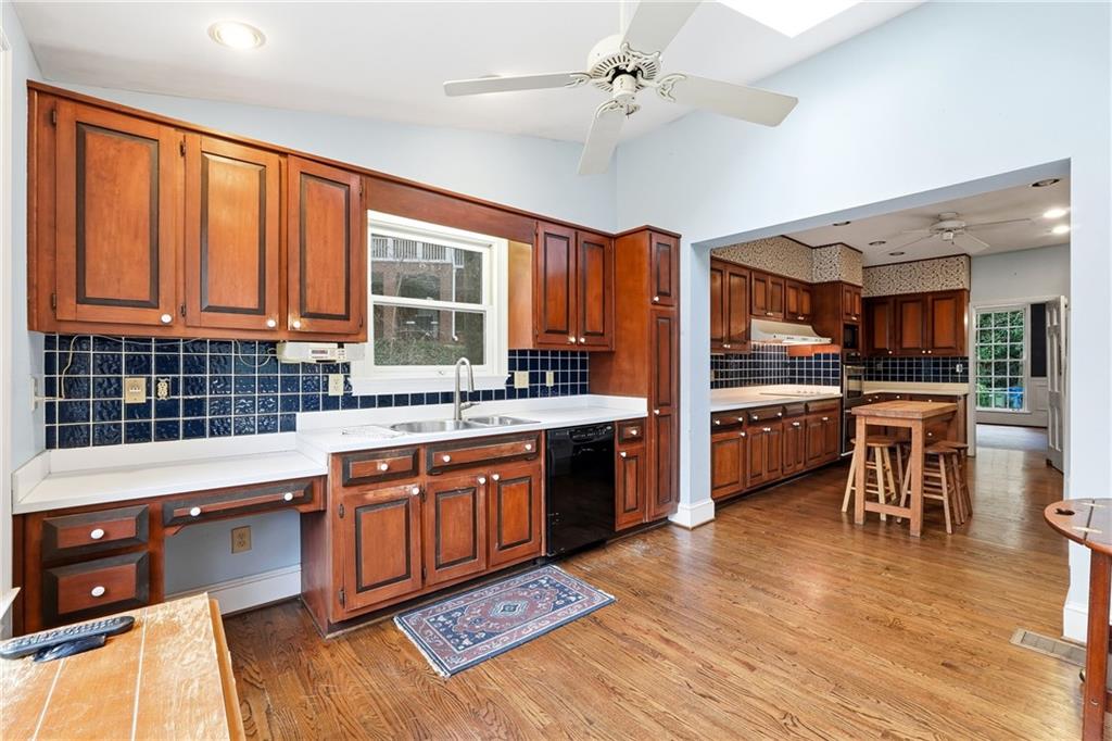 956 West Wesley Road Northwest Atlanta, GA 30327 - Photo 22 of 49 a kitchen with stainless steel appliances kitchen island granite countertop a stove refrigerator and a sink with granite countertops