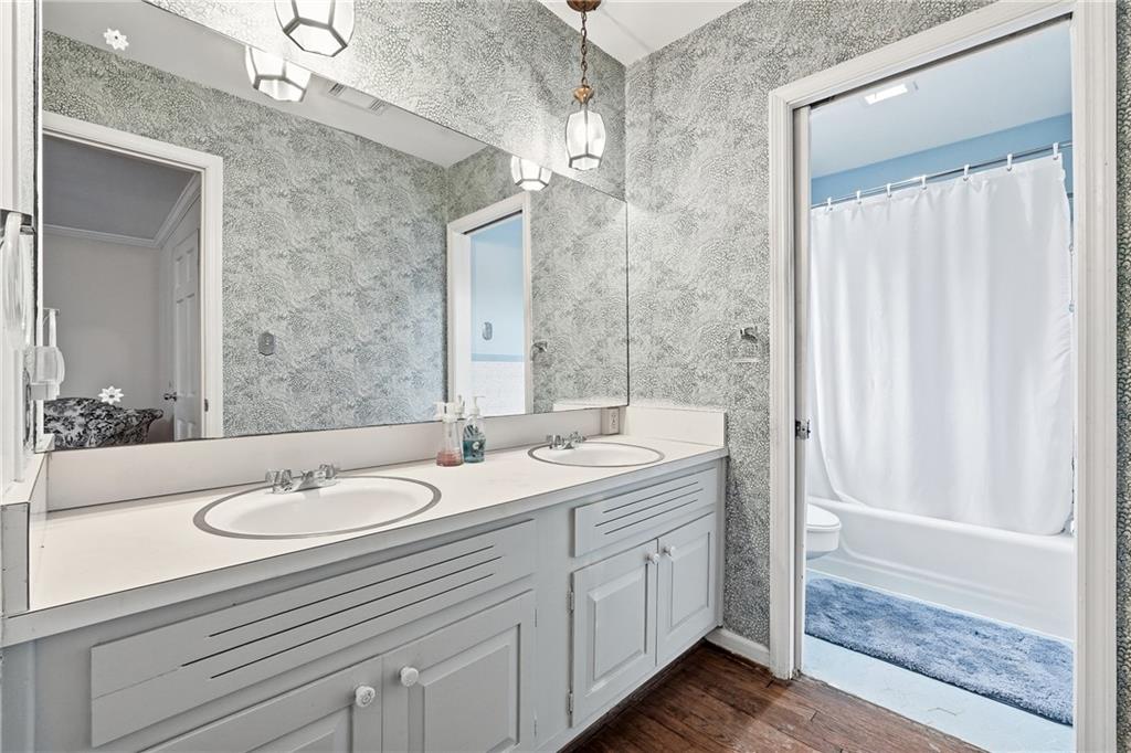 956 West Wesley Road Northwest Atlanta, GA 30327 - Photo 29 of 49 a bathroom with a double vanity sink and a mirror