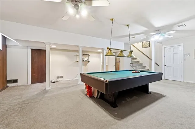 a room with pool table and wooden floor
