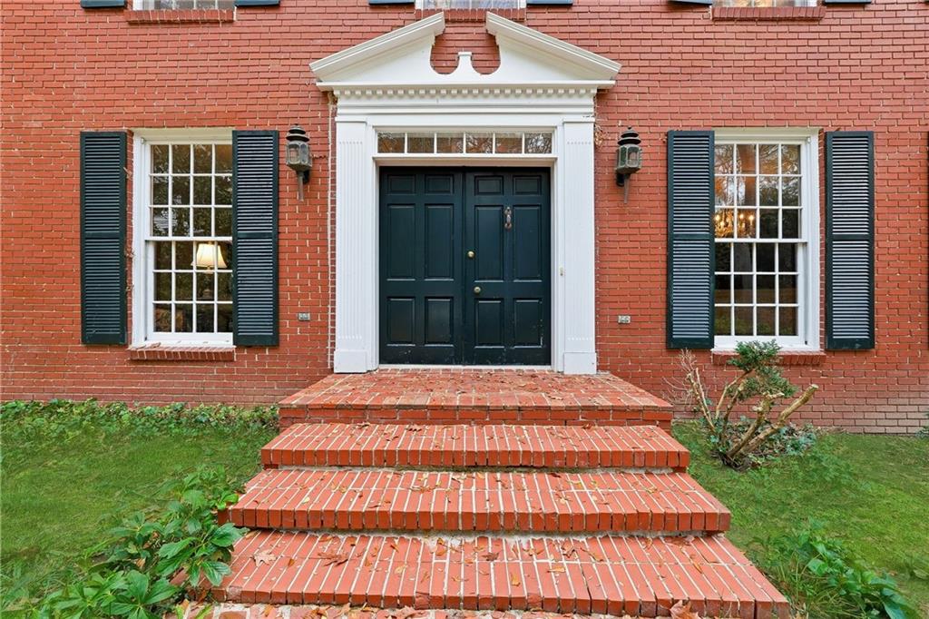 956 West Wesley Road Northwest Atlanta, GA 30327 - Photo 7 of 49 a front view of a house with a yard