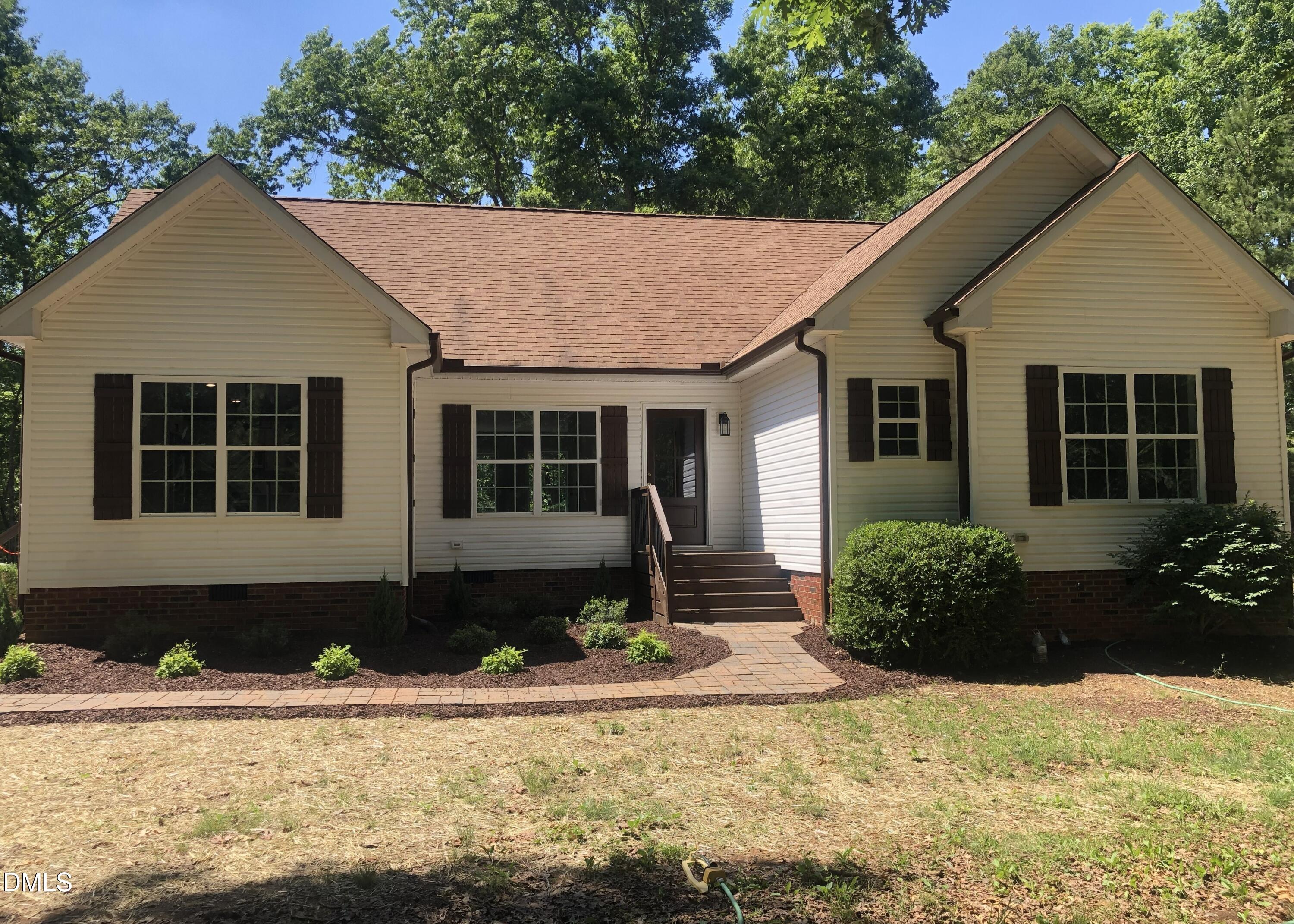 95 Smith Taylor Trail Roxboro, NC 27574 - Photo 2 of 47 a front view of a house with garden