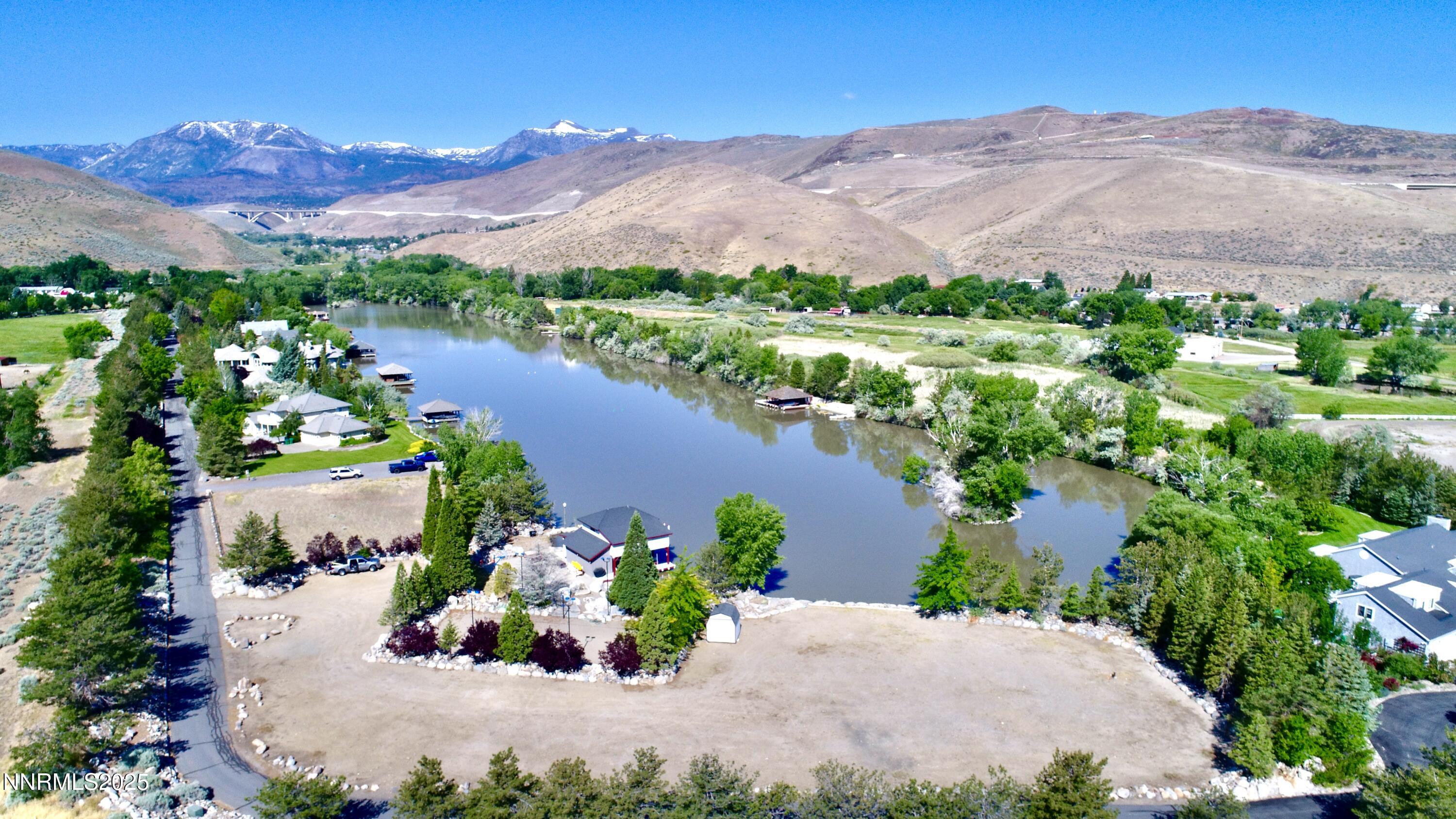 95 Hidden Lake Drive Reno, NV 89521 - Photo 2 of 43 a view of a lake with a mountain in the background