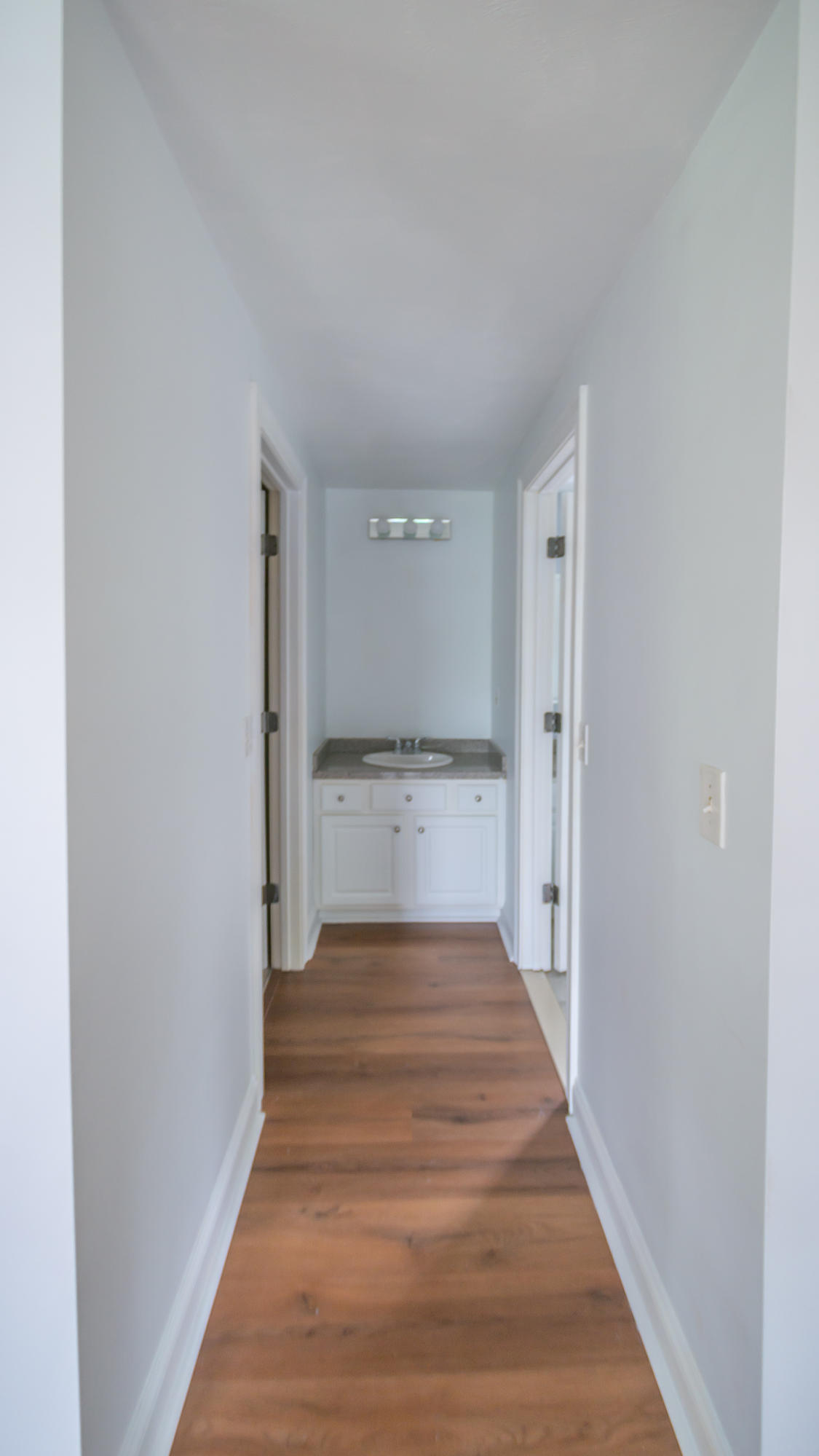 7 Webquish Lane Mashpee, MA 02649 - Photo 23 of 29 a view of a hallway with wooden floor and staircase