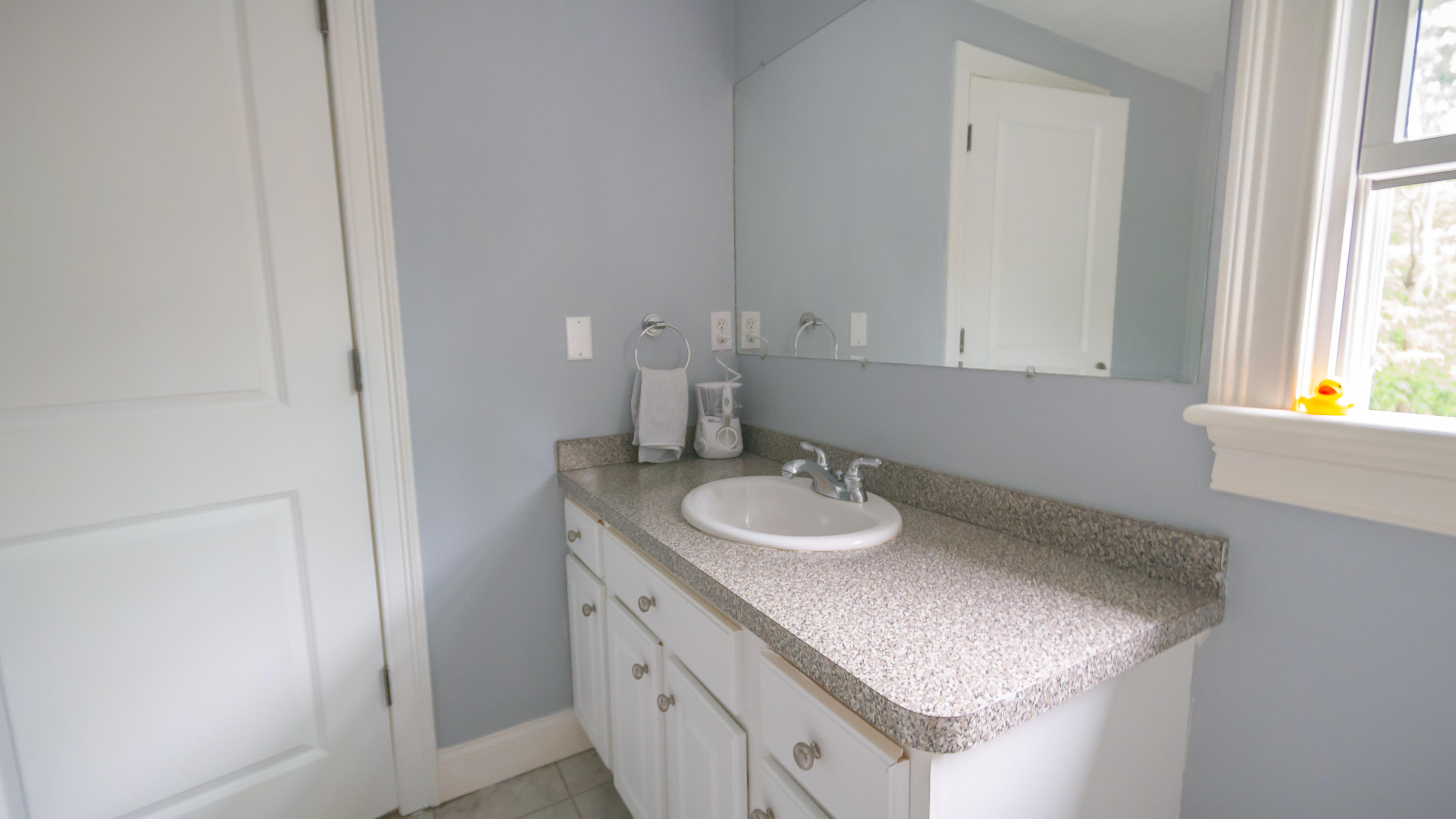 7 Webquish Lane Mashpee, MA 02649 - Photo 10 of 29 a bathroom with a granite countertop sink and a mirror