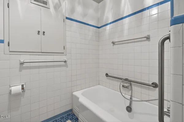 a view of empty room with wooden floor and cabinet