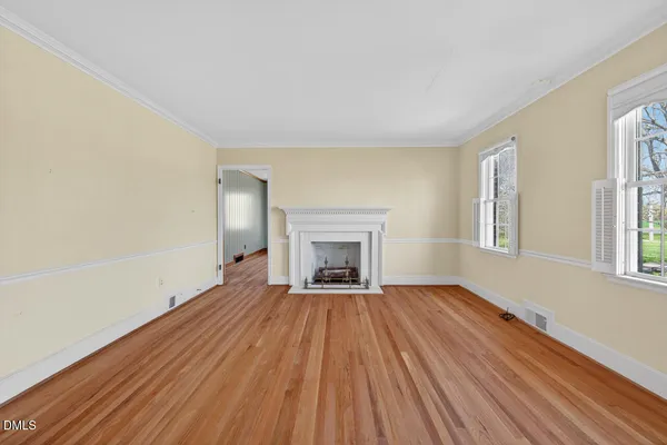 wooden floor fireplace and natural light in room