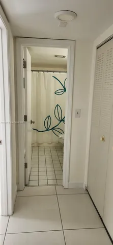 a bathroom with a glass door shower