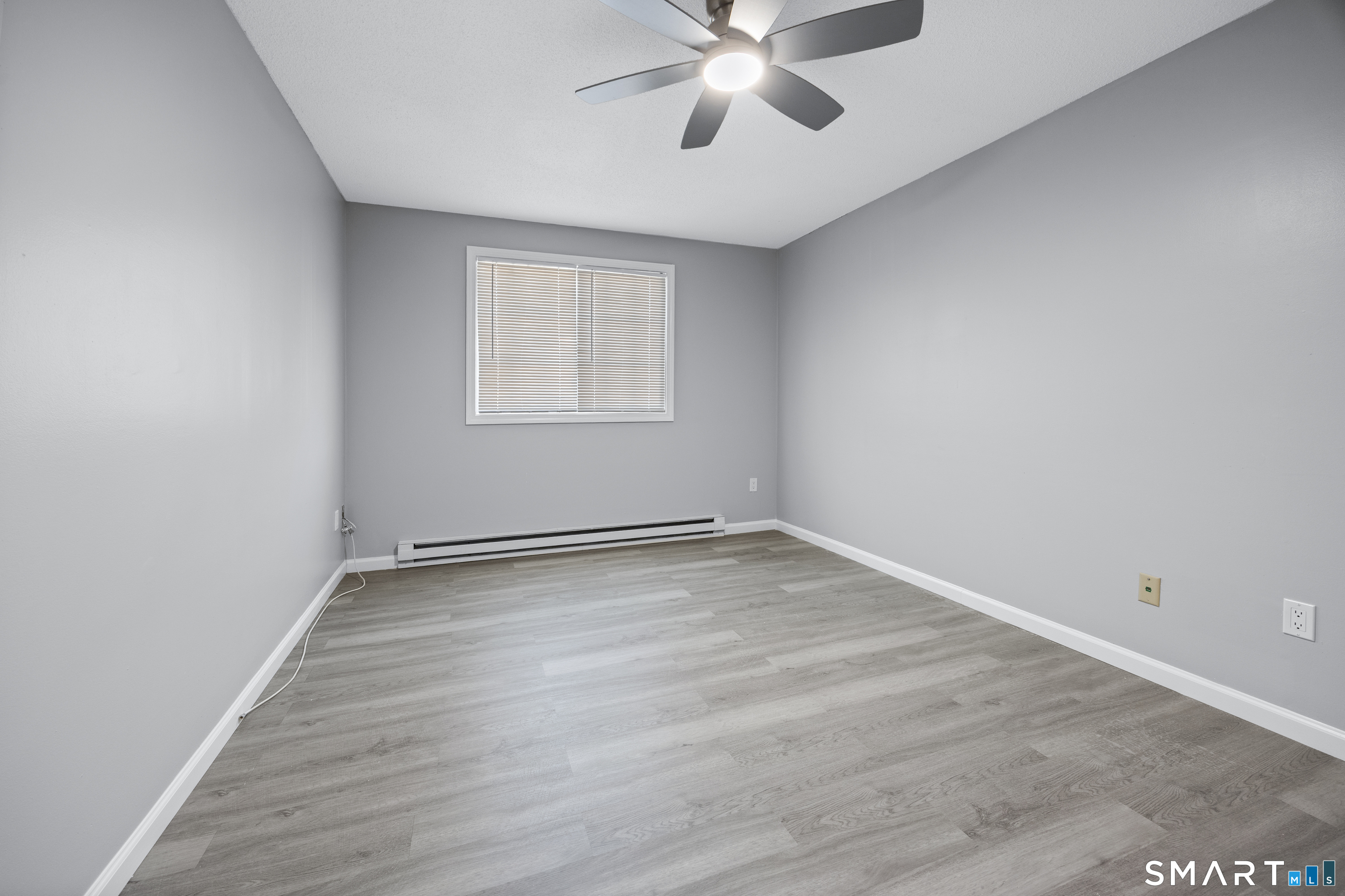 36 Sharon Road, Unit 11 Waterbury, CT 06705 - Photo 12 of 13 wooden floor in an empty room with a window