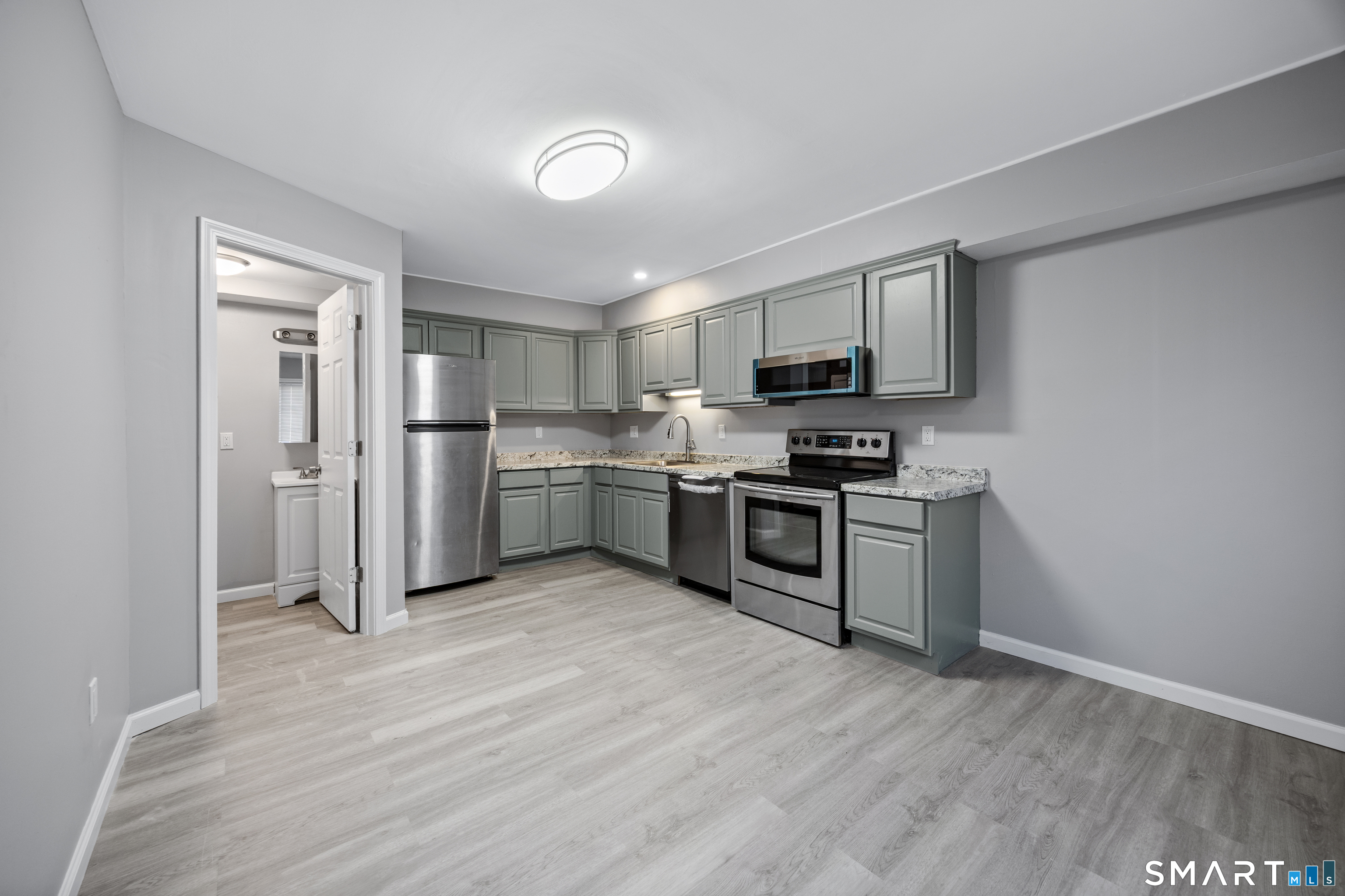 36 Sharon Road, Unit 11 Waterbury, CT 06705 - Photo 4 of 13 a kitchen with stainless steel appliances granite countertop a refrigerator stove top oven and sink