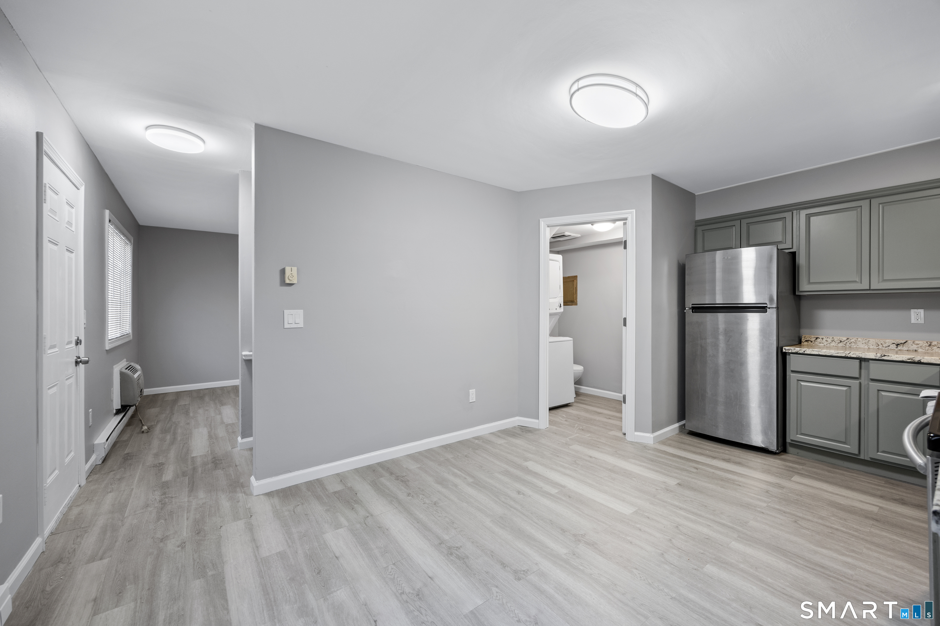 36 Sharon Road, Unit 11 Waterbury, CT 06705 - Photo 6 of 13 a view of a kitchen with a sink refrigerator and wooden floor