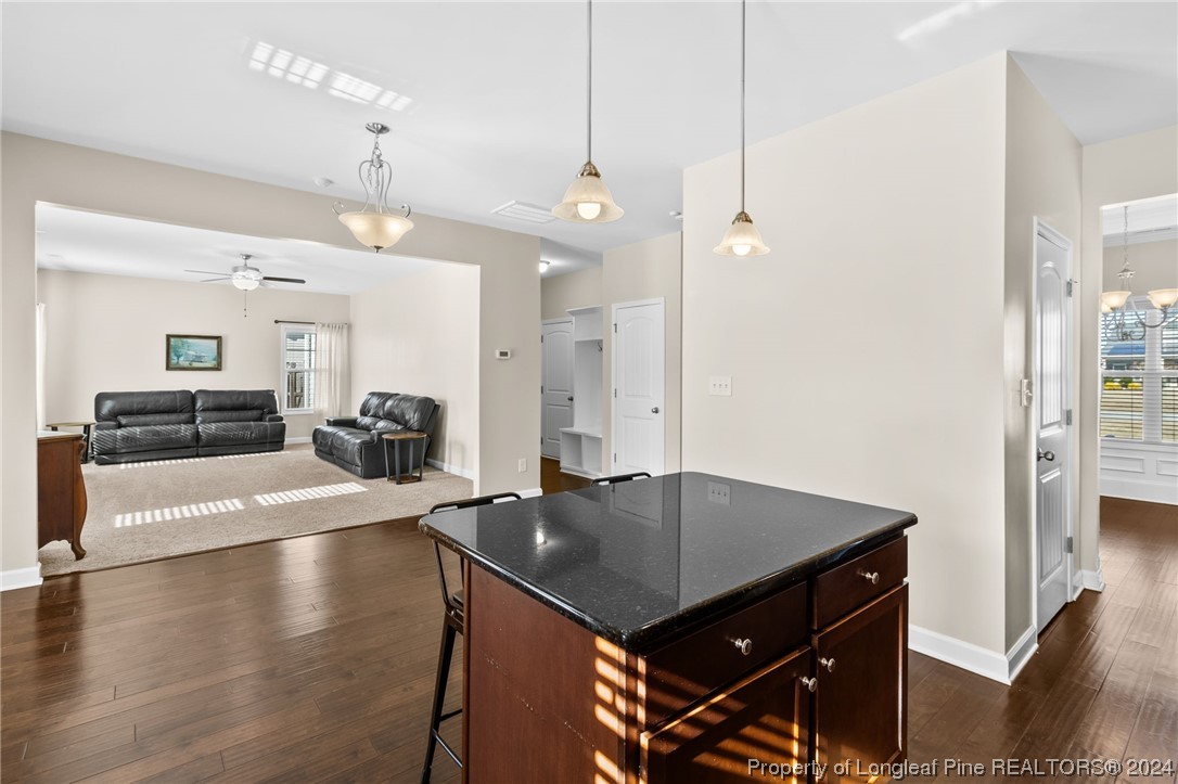 6817 Hunters Den Road Hope Mills, NC 28348 - Photo 14 of 49 a kitchen with a table chairs and living room