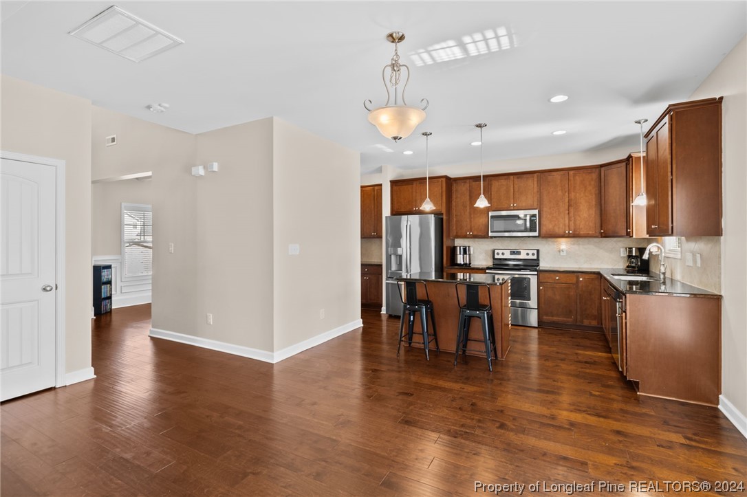 6817 Hunters Den Road Hope Mills, NC 28348 - Photo 15 of 49 a view of kitchen with stainless steel appliances refrigerator stove microwave and cabinets