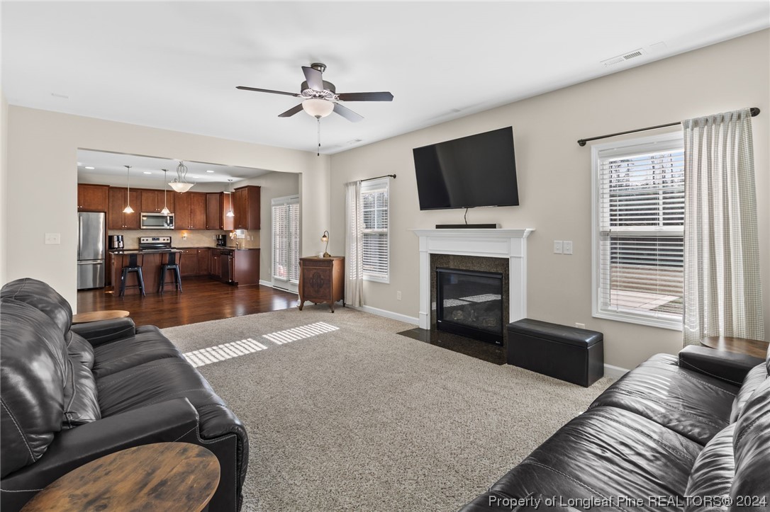 6817 Hunters Den Road Hope Mills, NC 28348 - Photo 19 of 49 a living room with furniture fireplace and flat screen tv