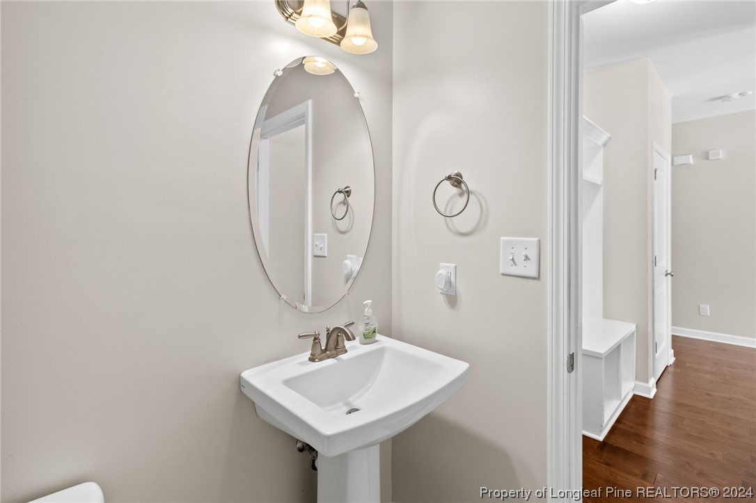 6817 Hunters Den Road Hope Mills, NC 28348 - Photo 23 of 49 a bathroom with a sink and mirror