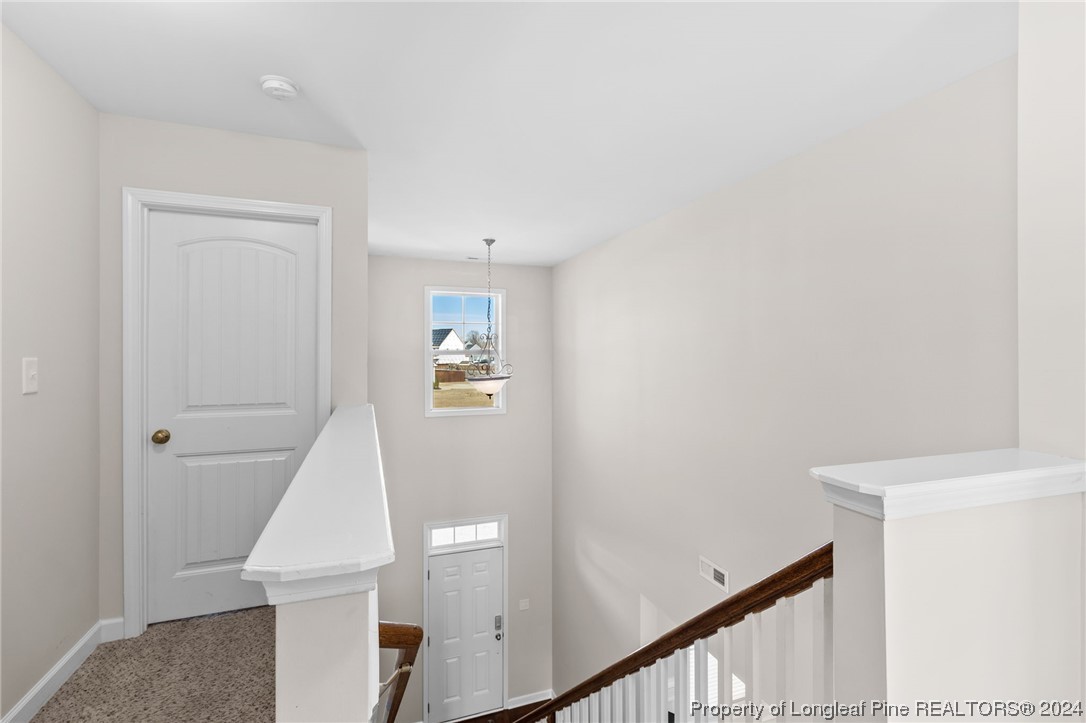 6817 Hunters Den Road Hope Mills, NC 28348 - Photo 24 of 49 a view of a hallway with windows
