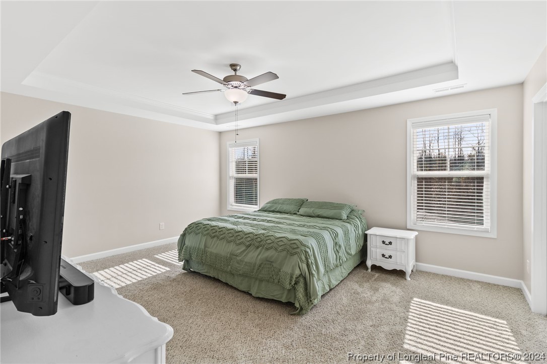 6817 Hunters Den Road Hope Mills, NC 28348 - Photo 25 of 49 a bedroom with a bed and a window