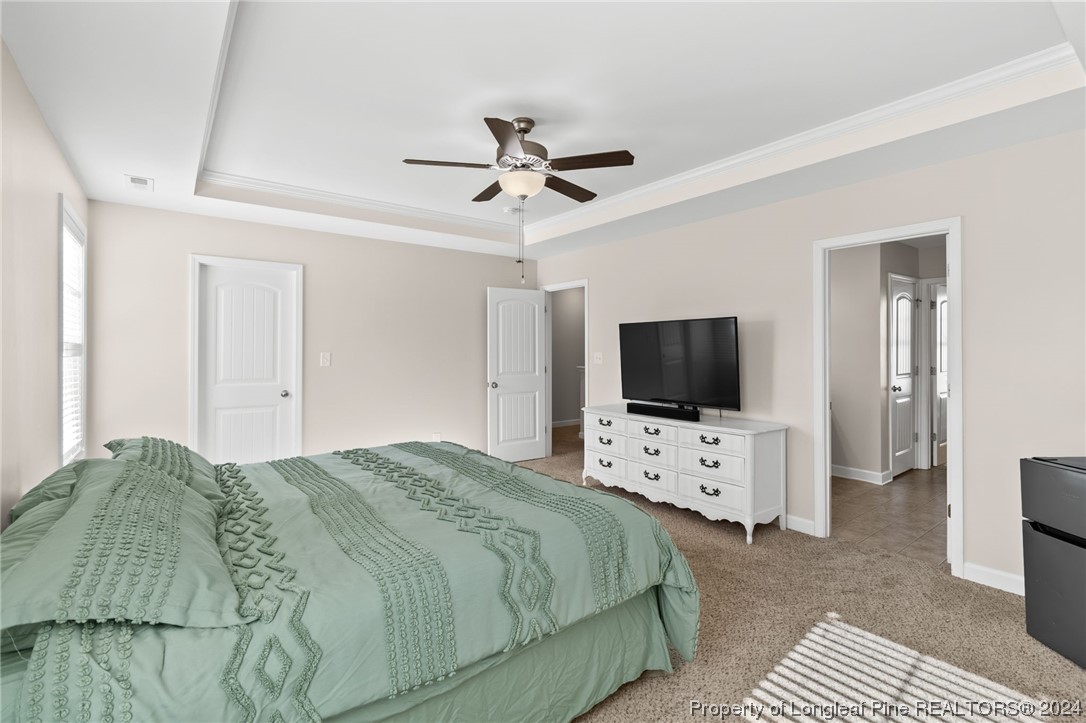 6817 Hunters Den Road Hope Mills, NC 28348 - Photo 26 of 49 a bedroom with a bed and a flat screen tv