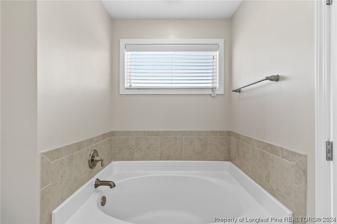 6817 Hunters Den Road Hope Mills, NC 28348 - Photo 29 of 49 a bathroom with a bathtub