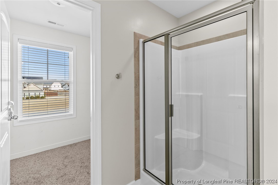 6817 Hunters Den Road Hope Mills, NC 28348 - Photo 30 of 49 a bathroom with a glass shower door