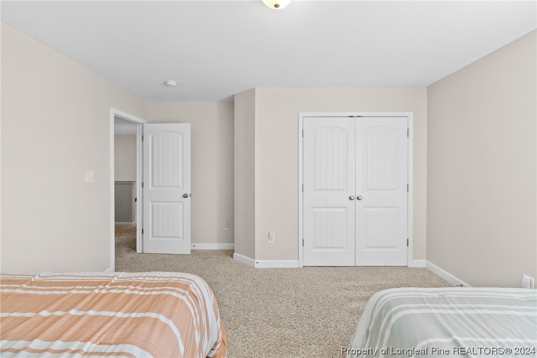 6817 Hunters Den Road Hope Mills, NC 28348 - Photo 33 of 49 a bedroom with a bed and pillows