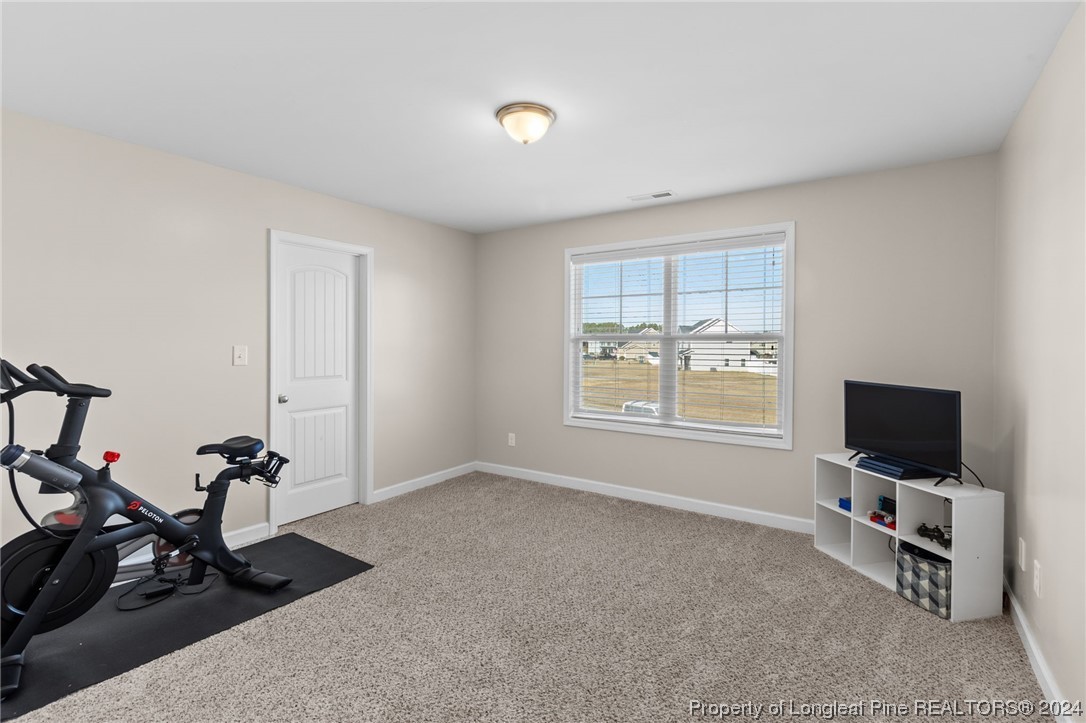 6817 Hunters Den Road Hope Mills, NC 28348 - Photo 38 of 49 a view of a room with gym equipment and a window