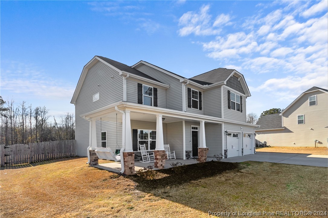 6817 Hunters Den Road Hope Mills, NC 28348 - Photo 4 of 49 a front view of a house with swimming pool and sitting area
