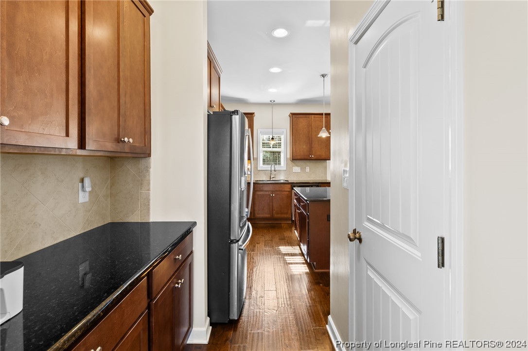 6817 Hunters Den Road Hope Mills, NC 28348 - Photo 9 of 49 a kitchen with a refrigerator and a sink