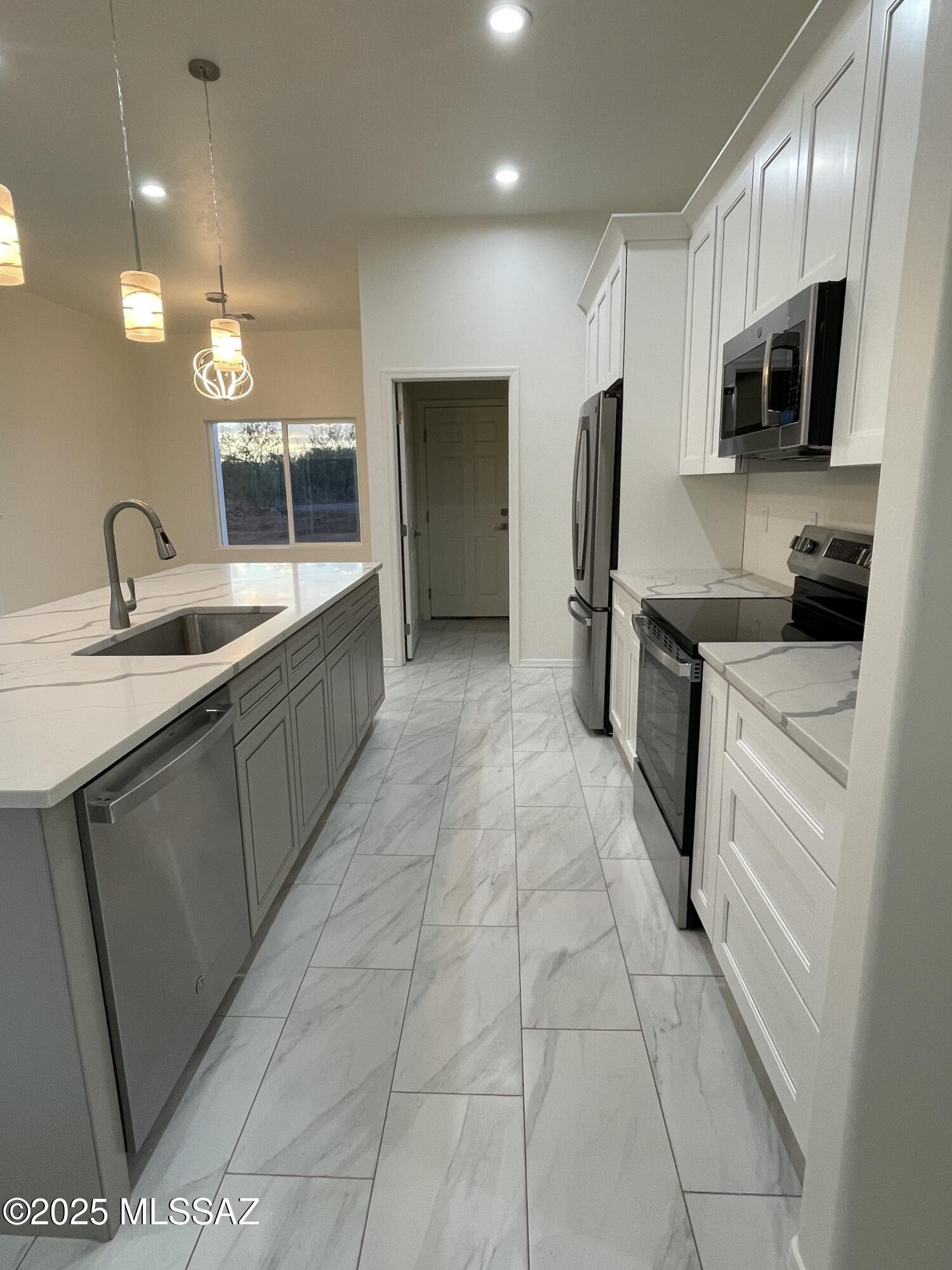 87 Avenida Pastor Rio Rico, AZ 85648 - Photo 10 of 24 a large kitchen with stainless steel appliances granite countertop a sink and cabinets