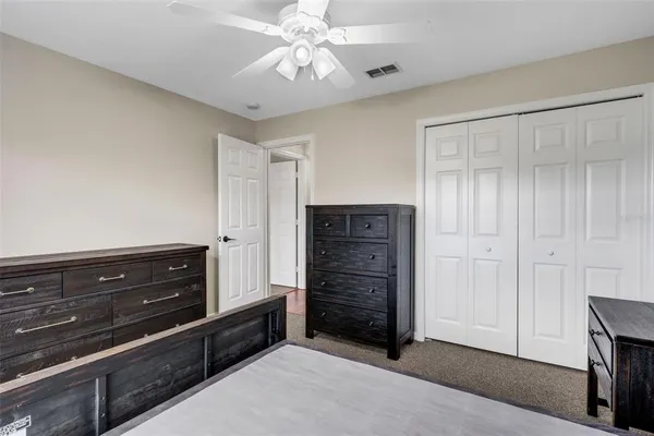 a view of a dresser with wooden floor and cabinet