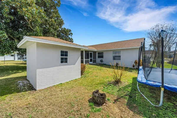 a view of a house with a backyard
