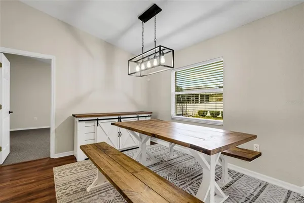 a view of a room with a table and chairs