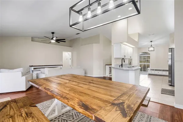 a bed room with a bed and a view of kitchen