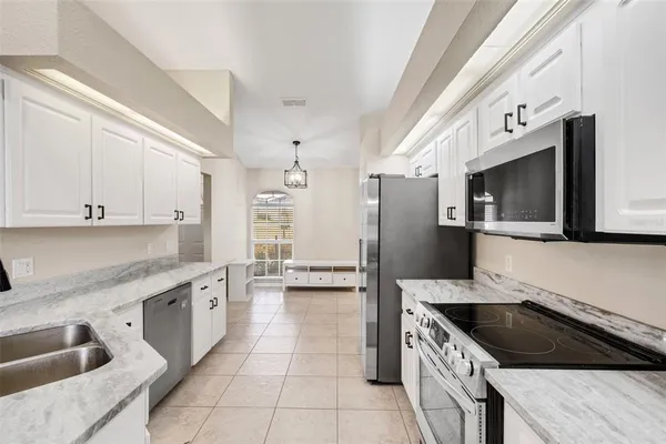 a kitchen with stainless steel appliances kitchen island granite countertop a sink and cabinets