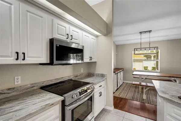 a kitchen with granite countertop a stove and a sink with granite countertops
