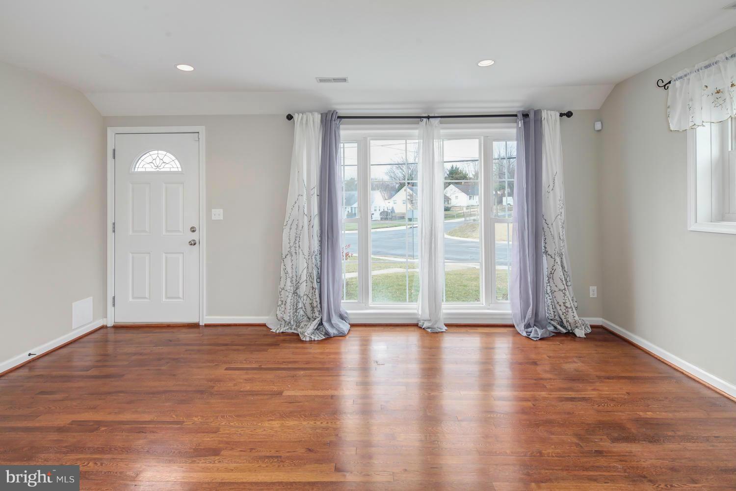 12601 Denley Road Silver Spring, MD 20906 - Photo 2 of 30 a view of an empty room with wooden floor and a window